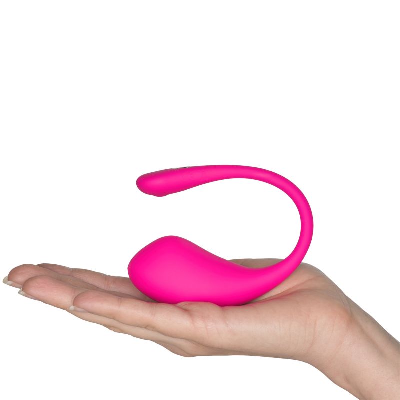 hånd der holder en lyserød vibrator